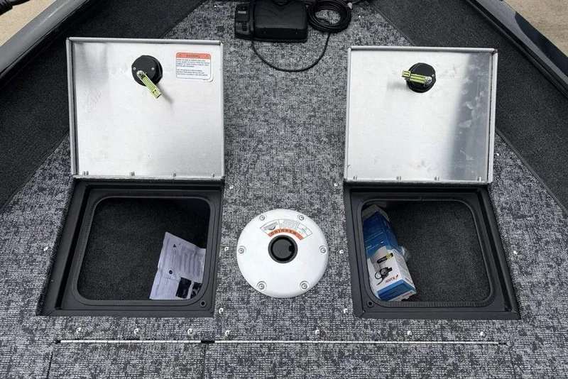 Slide: The Image of 2026 Tracker Pro Guide V-16 SC boat storage compartments with open lids and visible contents. - 8