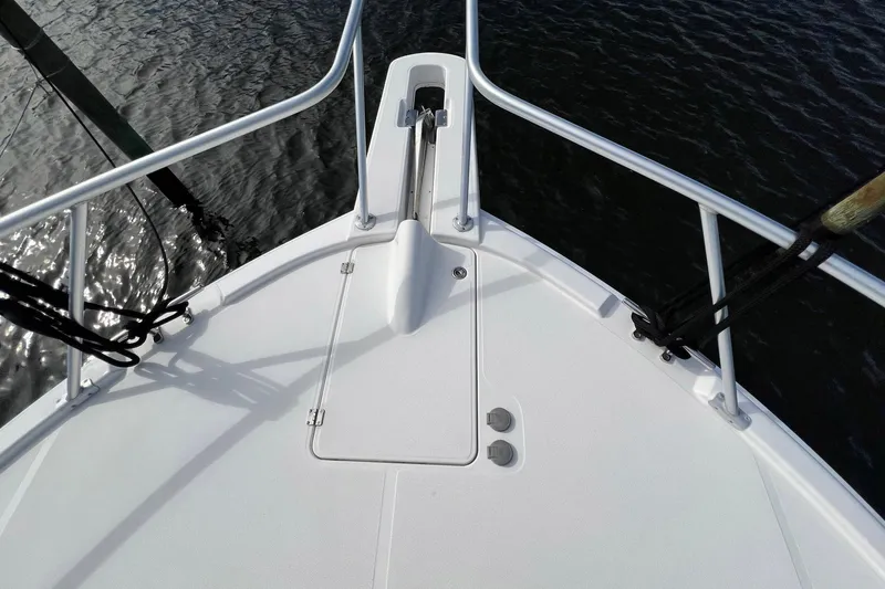 Slide: The Image of Bow of 2007 Luhrs 41 Hardtop boat with anchor and railing, over water. - 11