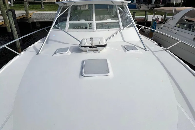 Slide: The Image of 2007 Luhrs 41 Hardtop boat deck with hatches and railing, docked at marina. - 12