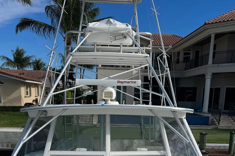 Slide: The Image of 2007 Luhrs 41 Hardtop boat with Raymarine equipment, docked near luxury homes. - 15