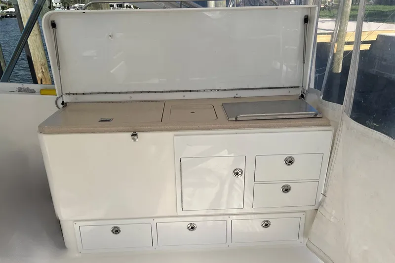 Slide: The Image of 2007 Luhrs 41 Hardtop boat interior with storage cabinets and countertop. - 22