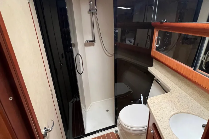 Slide: The Image of 2007 Luhrs 41 Hardtop yacht bathroom with shower, toilet, and sink. - 8