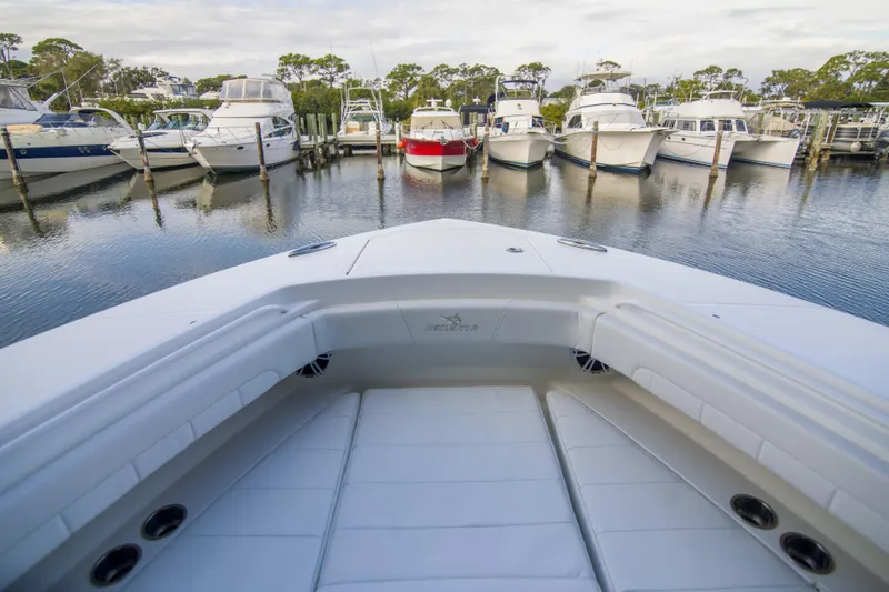 Slide: The Image of Bow view of 2021 Regulator 41 boat docked among other yachts in a marina. - 24