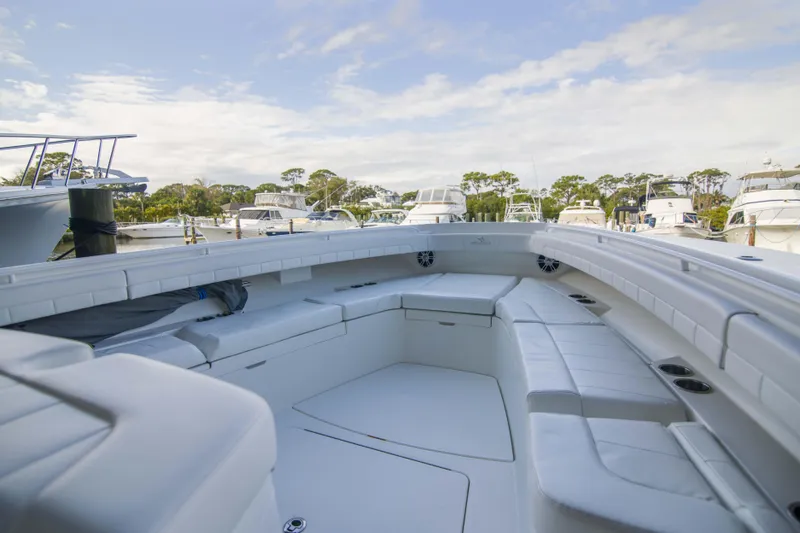 Slide: The Image of 2021 Regulator 41 boat interior with white seating, docked at a marina. - 27