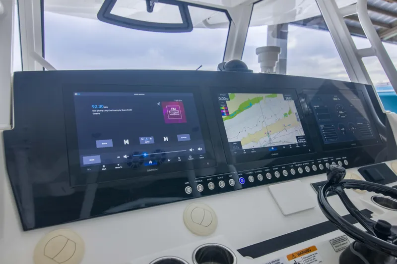Slide: The Image of Control panel of a 2021 Regulator 41 boat with navigation and audio displays. - 7