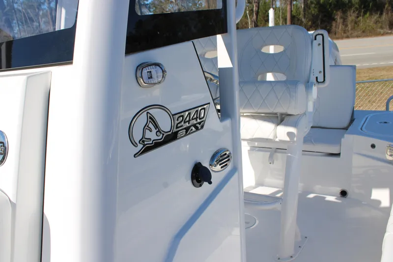 Slide: The Image of 2026 Blazer Bay 2440 boat interior with white seating and logo detail. - 12