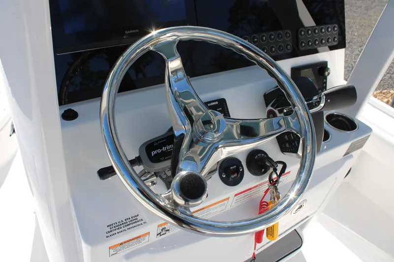 Slide: The Image of 2026 Blazer Bay 2440 boat steering console with chrome wheel and control panel. - 13