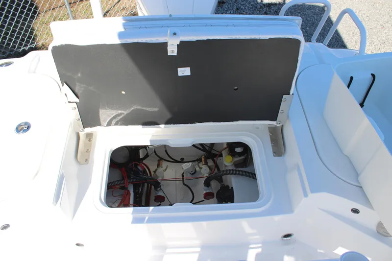Slide: The Image of Open storage compartment of 2026 Blazer Bay 2440 boat, showing internal wiring and components. - 17