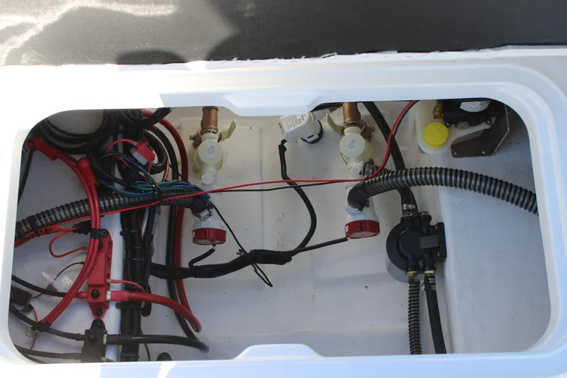 Slide: The Image of Electrical and plumbing components inside a 2026 Blazer Bay 2440 boat compartment. - 18