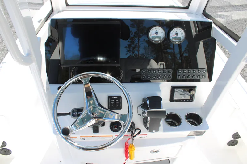 Slide: The Image of 2026 Blazer Bay 2440 boat dashboard with steering wheel, gauges, and controls. - 25