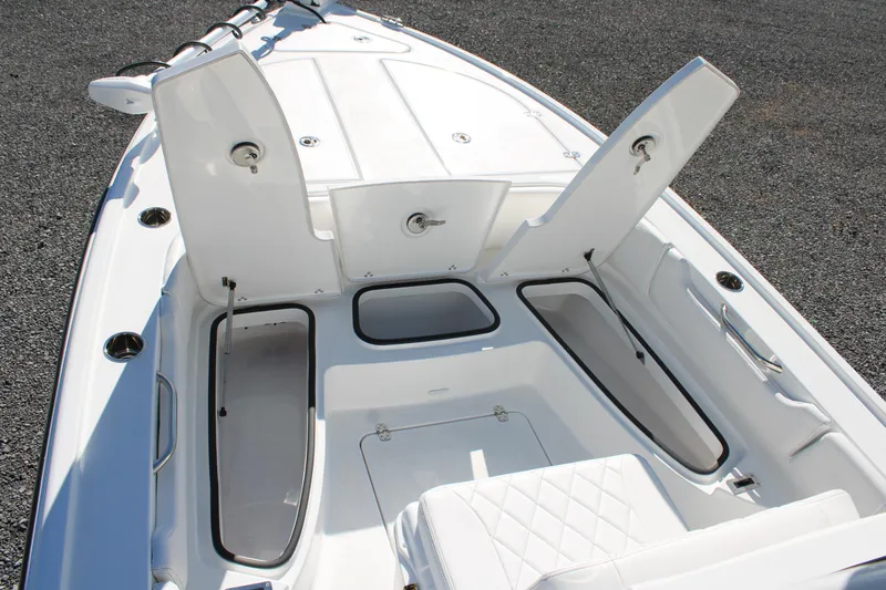 Slide: The Image of 2026 Blazer Bay 2440 boat interior with open storage compartments and seating. - 29