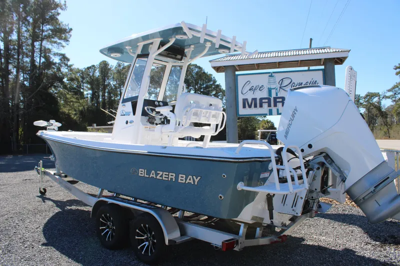 Slide: The Image of 2026 Blazer Bay 2440 boat with Mercury engine on trailer at marina. - 3