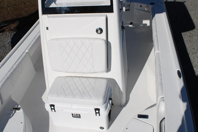 Slide: The Image of 2026 Blazer Bay 2440 boat interior with white cushioned seating and storage. - 34