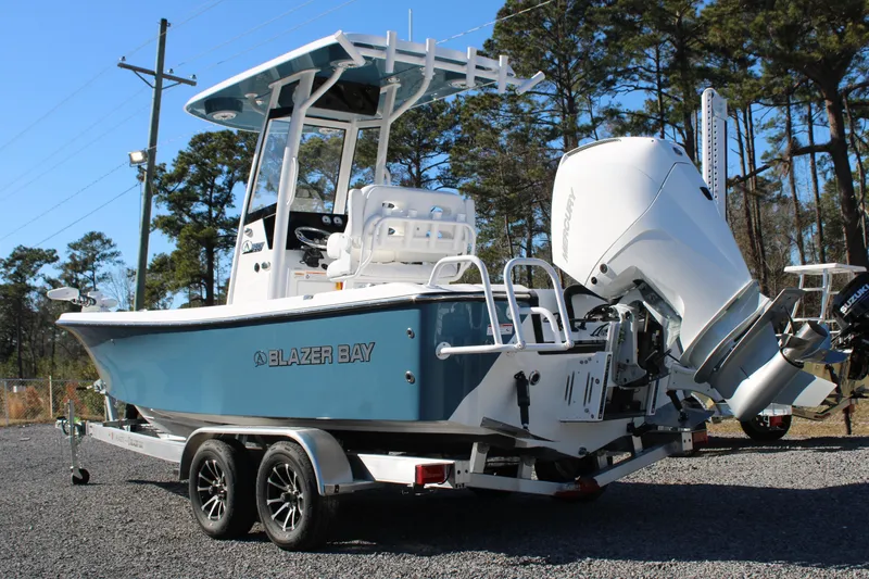 Slide: The Image of 2026 Blazer Bay 2440 boat on trailer, featuring a powerful outboard motor. - 4