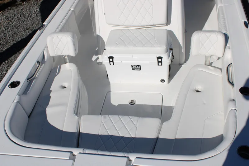 Slide: The Image of 2026 Blazer Bay 2440 boat interior with white seating and cooler. - 40