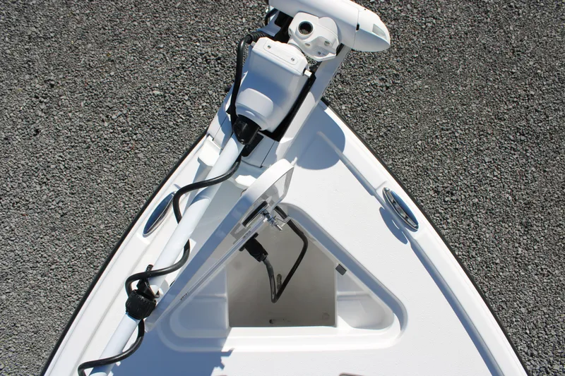 Slide: The Image of Bow of 2026 Blazer Bay 2440 boat with trolling motor on gravel surface. - 44
