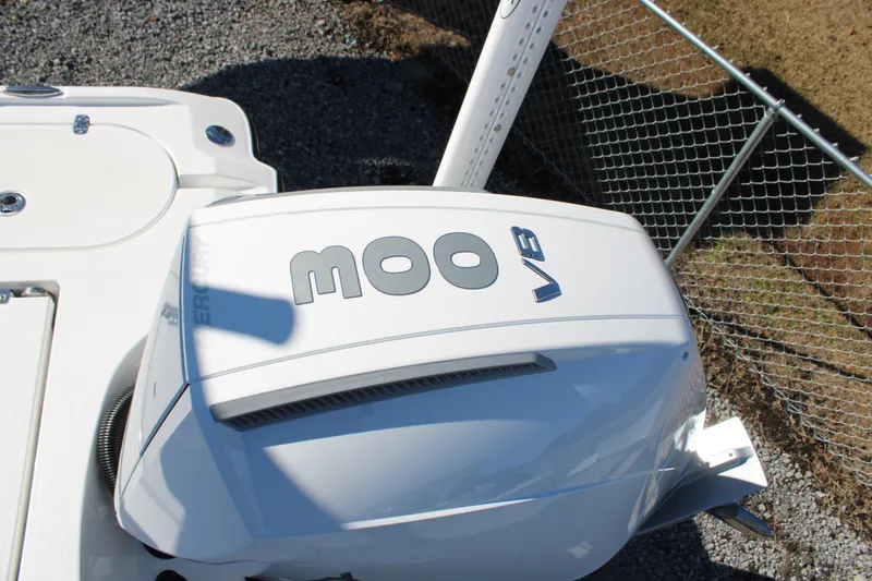 Slide: The Image of 2026 Blazer Bay 2440 boat with powerful V8 engine, parked near a chain-link fence. - 52