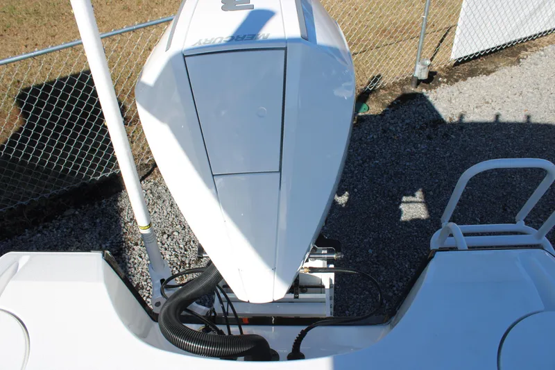 Slide: The Image of 2026 Blazer Bay 2440 boat engine, top view, near chain-link fence. - 53