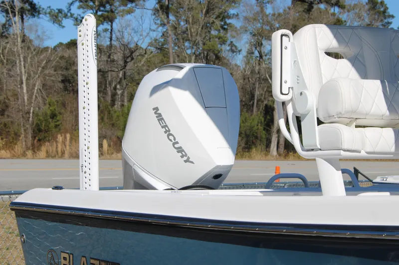 Slide: The Image of 2026 Blazer Bay 2440 boat with Mercury engine and white seating. - 57