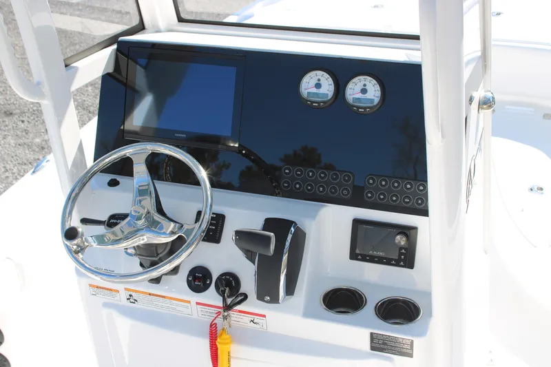 Slide: The Image of 2026 Blazer Bay 2440 boat dashboard with steering wheel and control panel. - 6