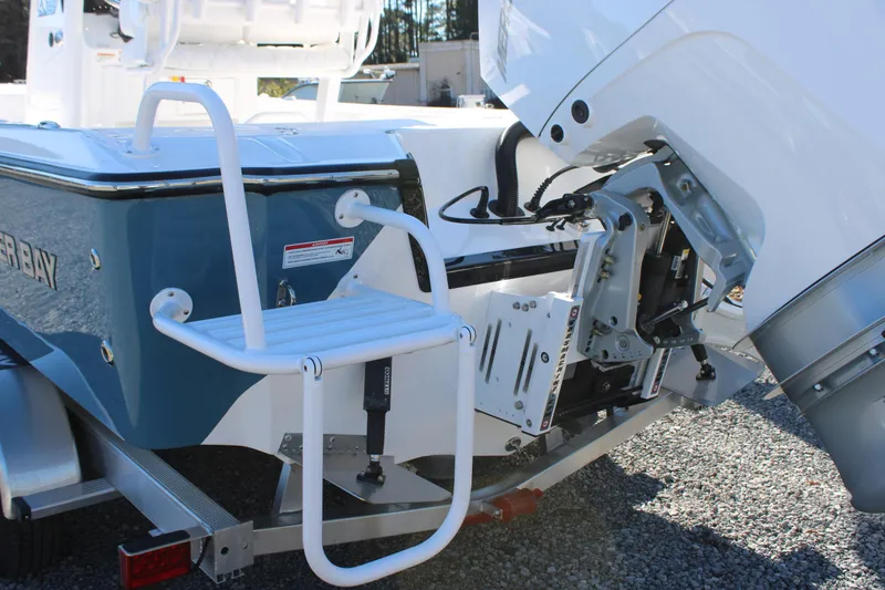 Slide: The Image of 2026 Blazer Bay 2440 boat with motor and swim ladder on trailer. - 61