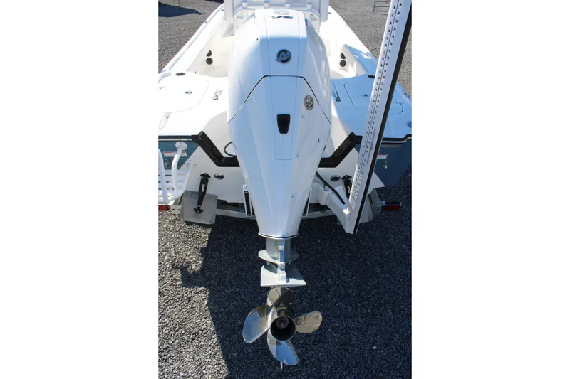 Slide: The Image of 2026 Blazer Bay 2440 boat with outboard motor and propeller, rear view. - 63