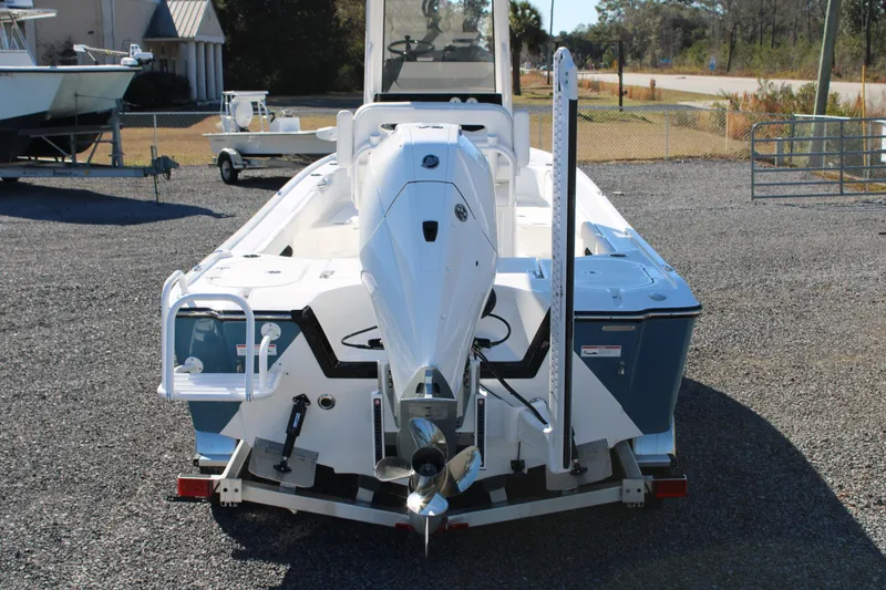 Slide: The Image of 2026 Blazer Bay 2440 boat, rear view, parked on gravel lot. - 65