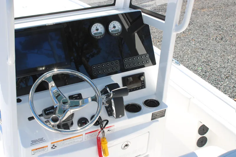 Slide: The Image of 2026 Blazer Bay 2440 boat console with steering wheel, gauges, and controls. - 7