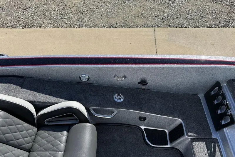 Slide: The Image of 2026 Phoenix 818 Pro boat interior with open storage compartment and quilted seating. - 13