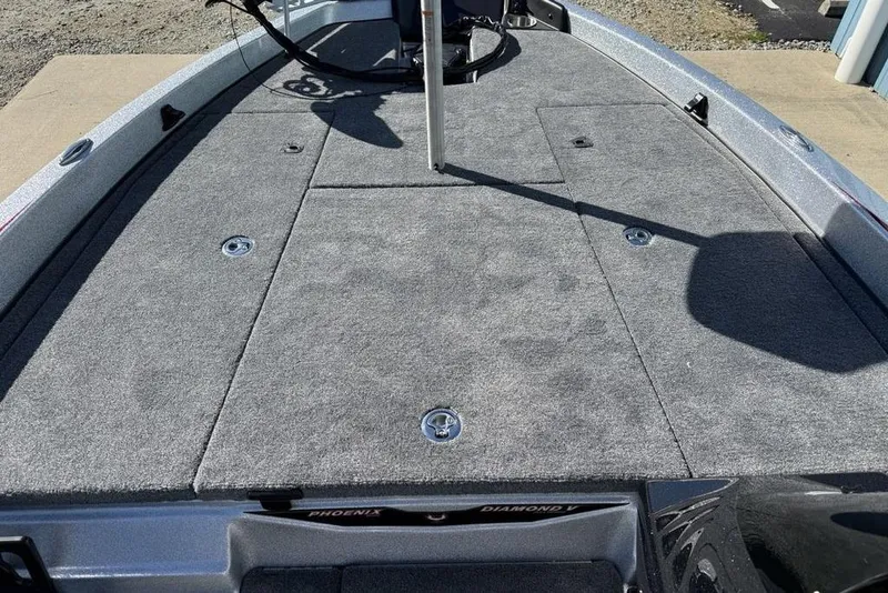 Slide: The Image of 2026 Phoenix 818 Pro boat interior with gray carpet and storage compartment. - 8