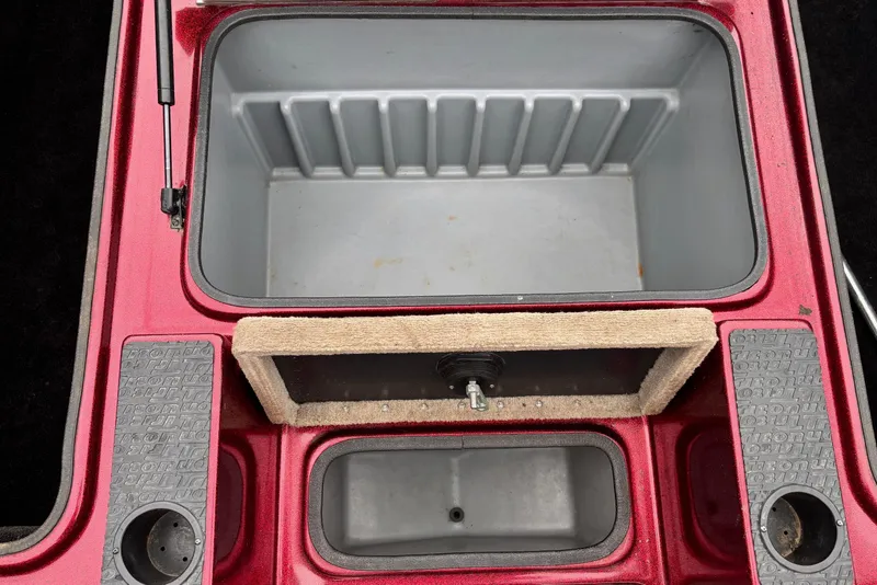 Slide: The Image of 2004 Triton Tr-20XDC boat storage compartments with red trim and textured footrests. - 15