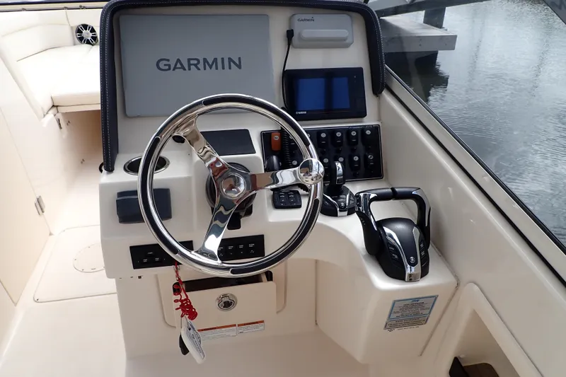 Slide: The Image of 2021 Grady-White Freedom 275 helm with Garmin navigation and Yamaha controls. - 13