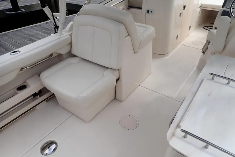 Slide: The Image of 2021 Grady-White Freedom 275 boat interior with white seating and sleek design. - 17