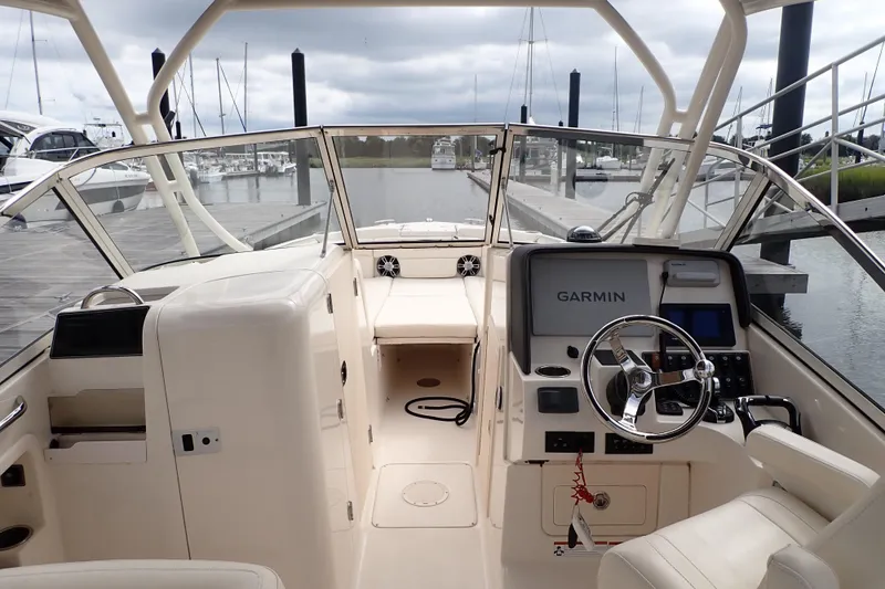 Slide: The Image of 2021 Grady-White Freedom 275 boat interior with Garmin navigation system at dock. - 18
