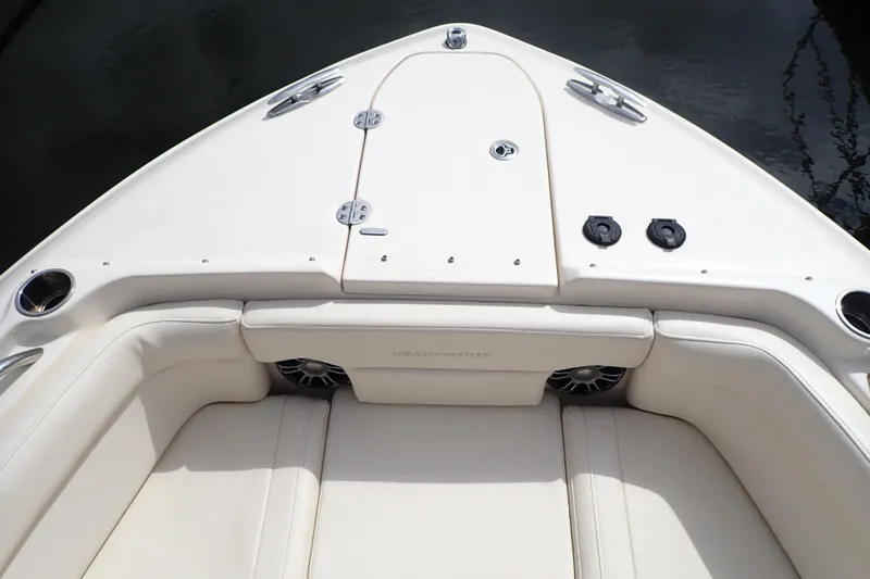 Slide: The Image of 2021 Grady-White Freedom 275 boat interior with cushioned seating and storage compartments. - 27