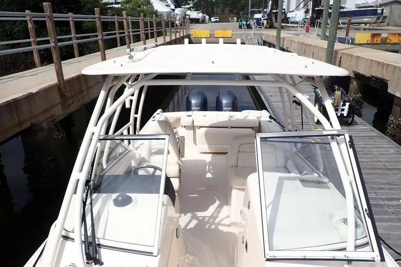 Slide: The Image of 2021 Grady-White Freedom 275 boat docked, featuring dual engines and spacious seating. - 29