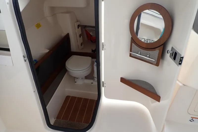 Slide: The Image of 2021 Grady-White Freedom 275 boat interior with toilet and mirror. - 37