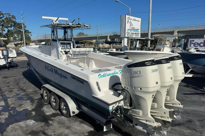 The Image of 2005 Contender 36 Cuddy boat with triple Suzuki 300 engines on a trailer. - 0