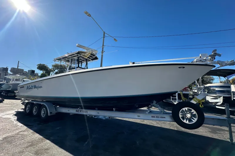Slide: The Image of 2005 Contender 36 Cuddy boat on trailer under bright blue sky. - 10