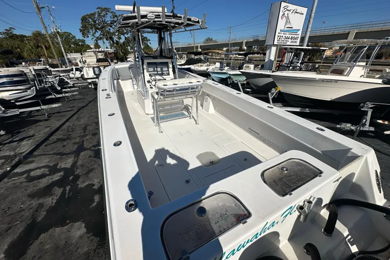 Slide: The Image of 2005 Contender 36 Cuddy boat displayed at a dealership, showcasing spacious deck and seating. - 11
