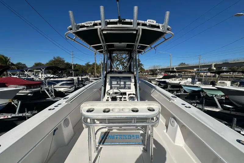 Slide: The Image of 2005 Contender 36 Cuddy boat interior with steering console and rod holders. - 15