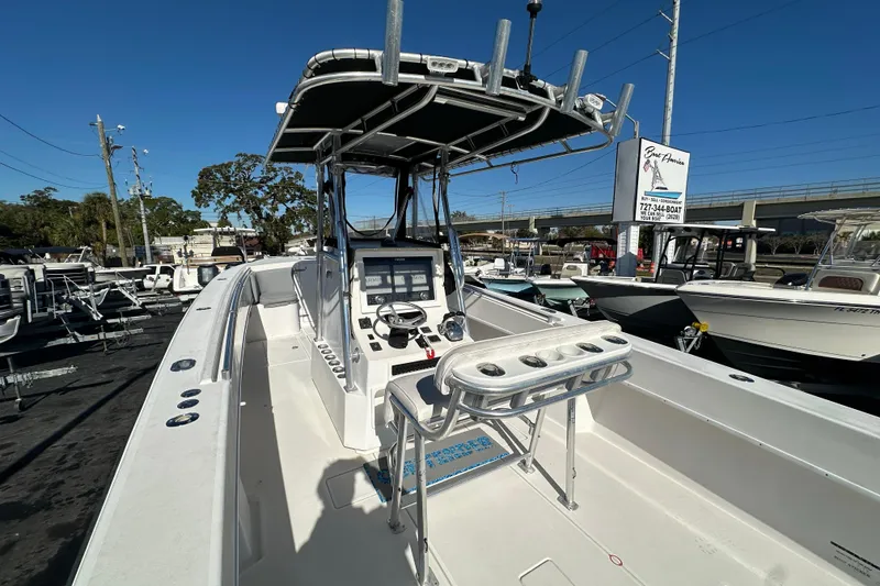 Slide: The Image of 2005 Contender 36 Cuddy boat with center console and T-top in a marina setting. - 16
