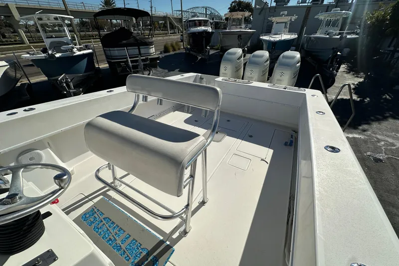 Slide: The Image of 2005 Contender 36 Cuddy boat interior with seating and triple outboard engines. - 17