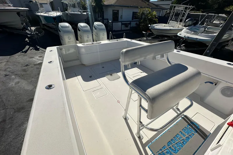 Slide: The Image of 2005 Contender 36 Cuddy boat interior with seating and triple outboard engines. - 19
