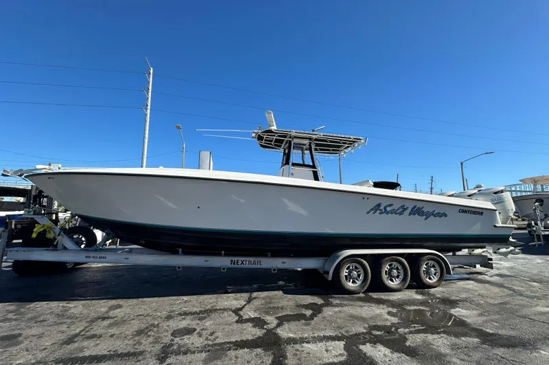 Slide: The Image of 2005 Contender 36 Cuddy boat on trailer under clear blue sky. - 2