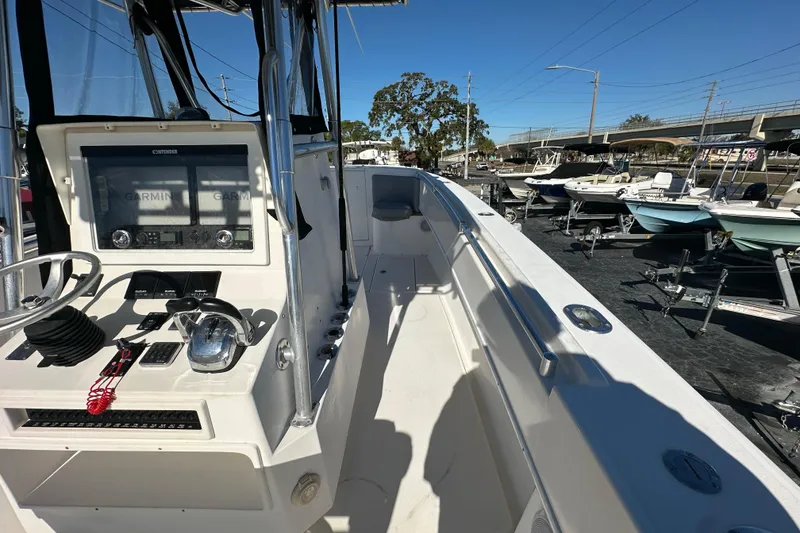 Slide: The Image of 2005 Contender 36 Cuddy boat interior with Garmin navigation system, docked among other boats. - 23