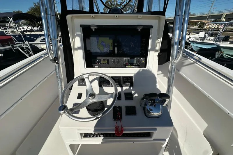 Slide: The Image of 2005 Contender 36 Cuddy helm with steering wheel, navigation screens, and controls. - 24