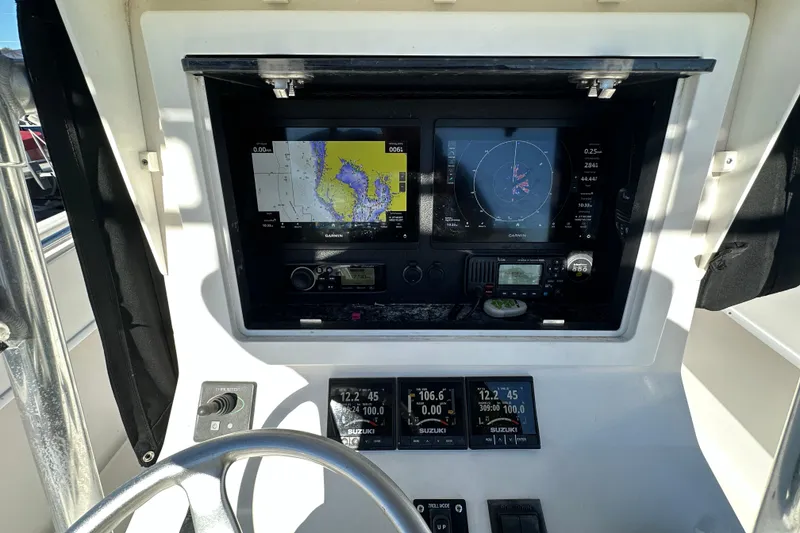 Slide: The Image of 2005 Contender 36 Cuddy helm with Garmin navigation displays and Suzuki engine monitors. - 25