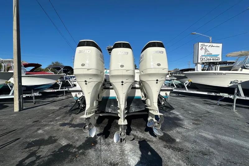 Slide: The Image of 2005 Contender 36 Cuddy with triple 300 horsepower outboard engines, parked at a dealership. - 5