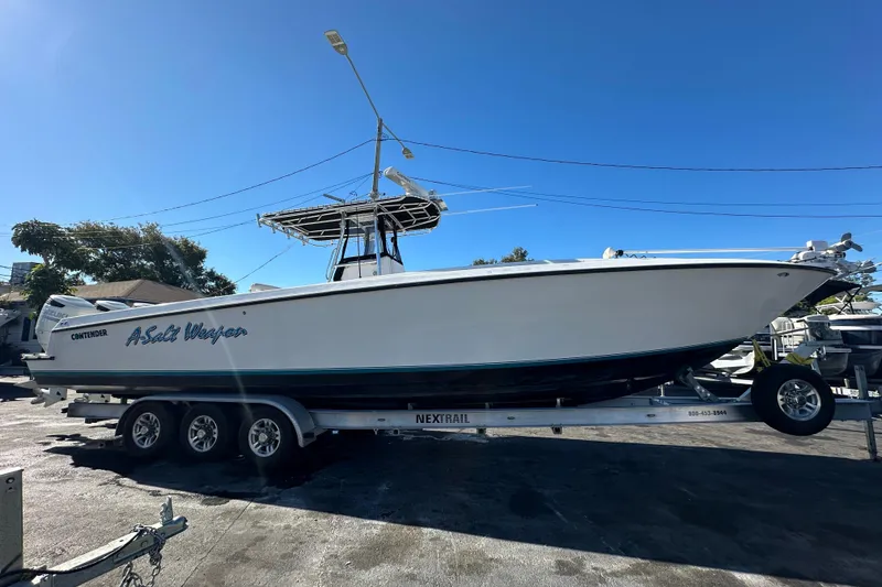 Slide: The Image of 2005 Contender 36 Cuddy boat on trailer under clear blue sky. - 9
